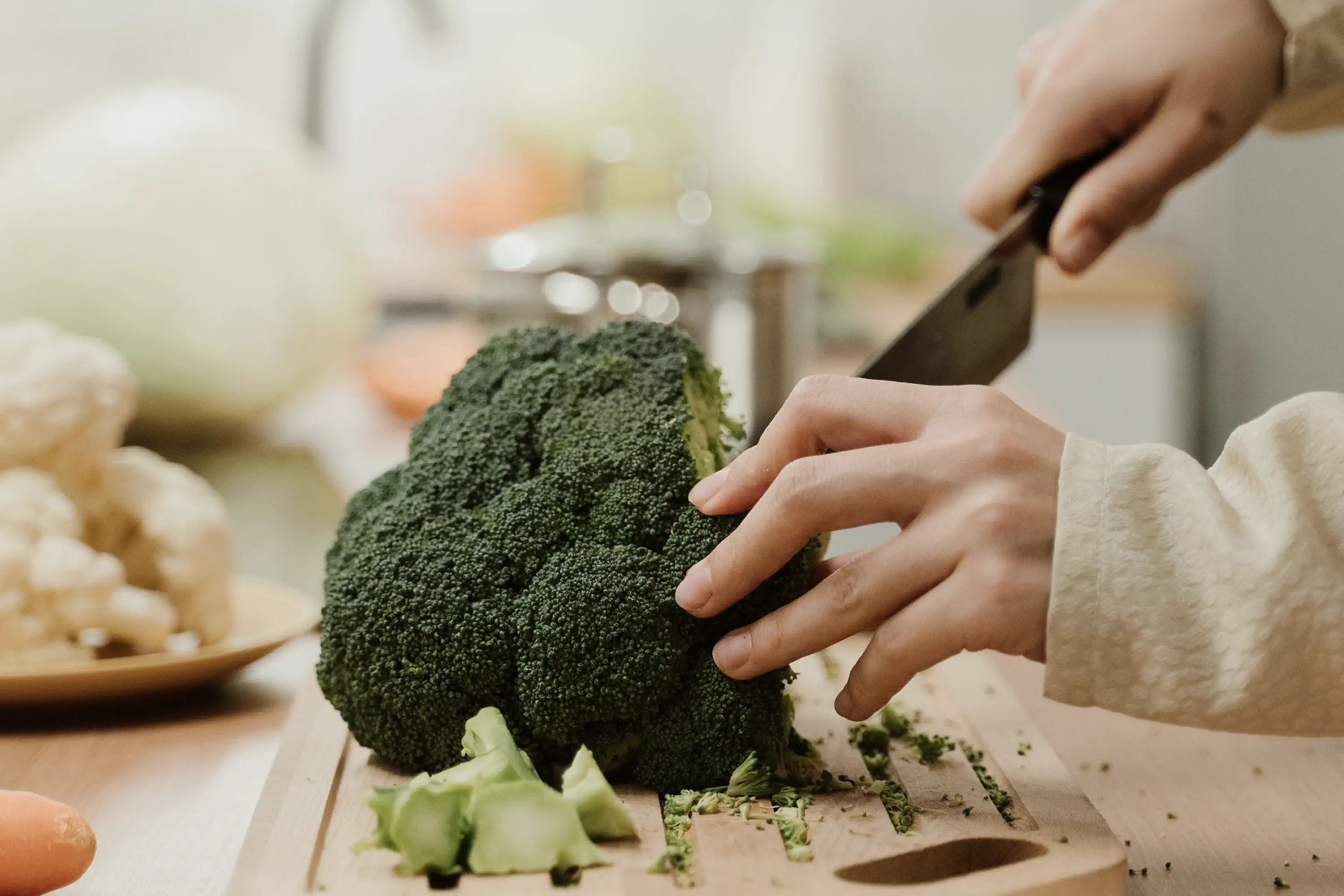 person chopping broccoli